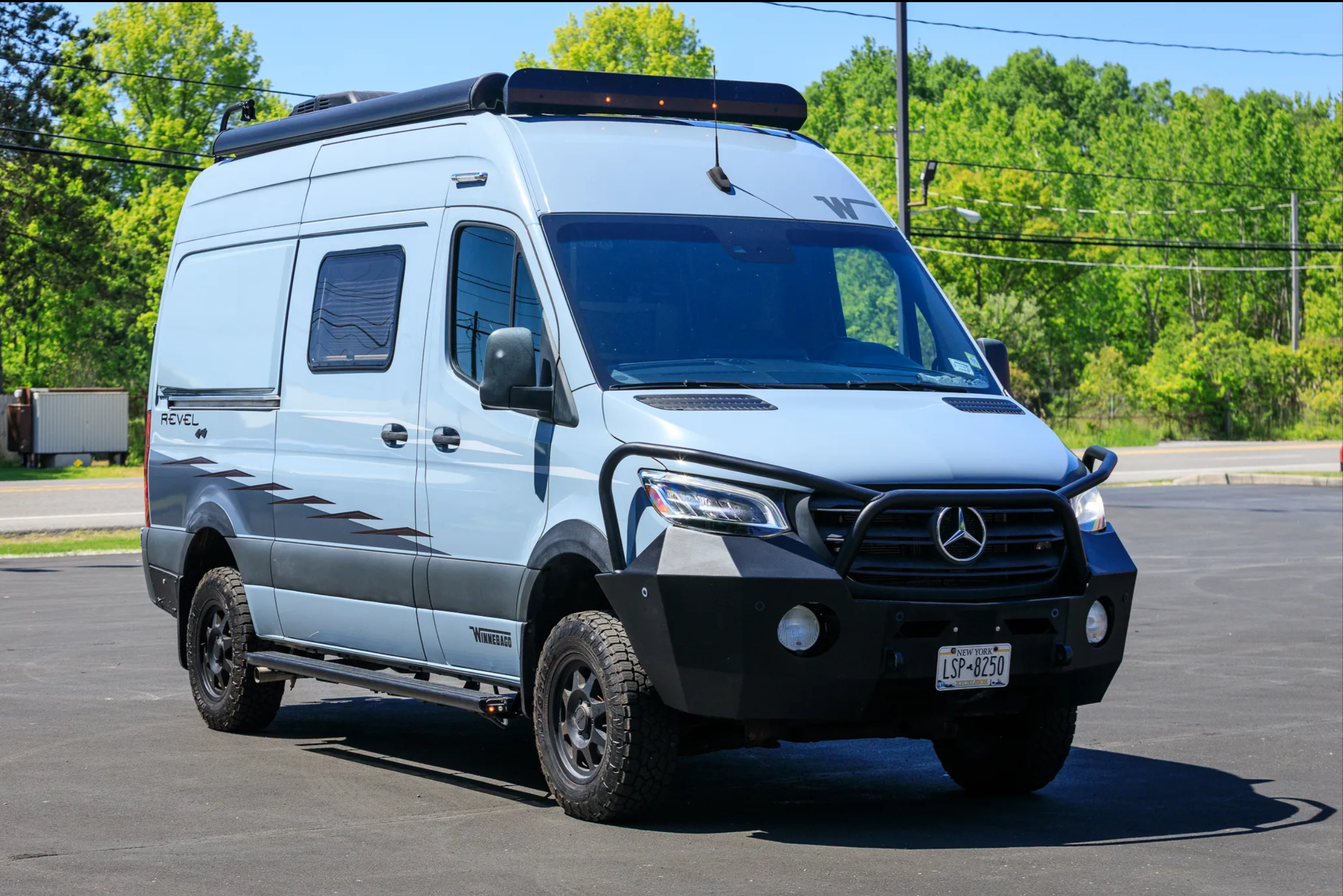 Front quarter view — Winnebago Revel with bull bar and off-road tires